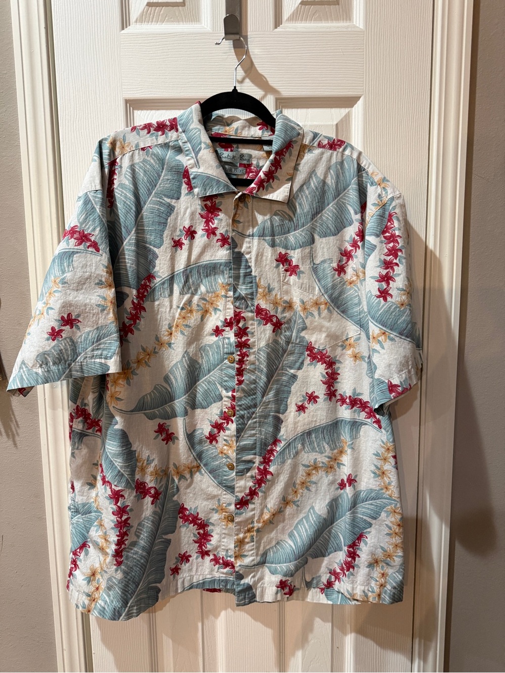 Men’s Batik Bay Hawaiian shirt features a reverse print design tropical floral